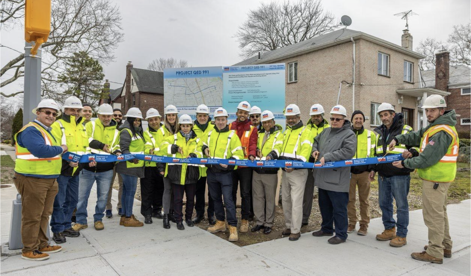 DDC Commissioner Thomas Foley (center), the DDC project team, consultants and contractors celebrate the completion of the $79.7 million project that rebuilt 3.5 miles of streets.